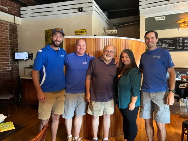 New England Clean Energy team members celebrating the company's leadership transition